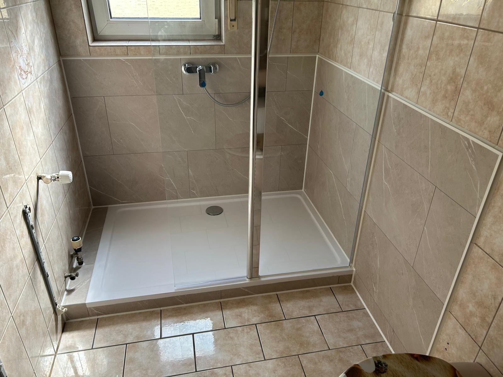 Nachher: große Dusche mit Glaswand in der Ecke